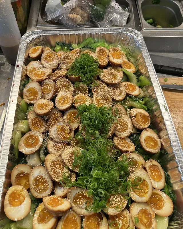 Tray of soy-marinated eggs on bok choy