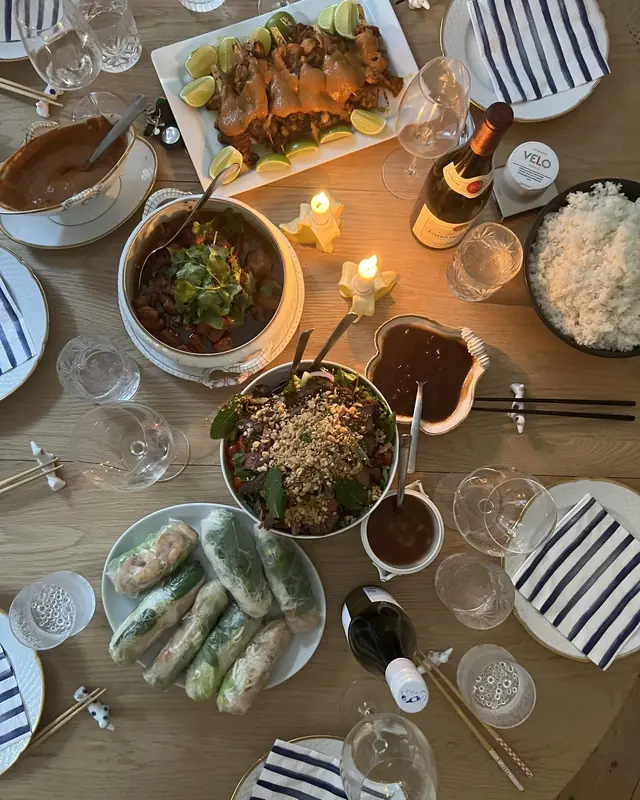 Sharing table with fresh spring rolls, rice and sauces