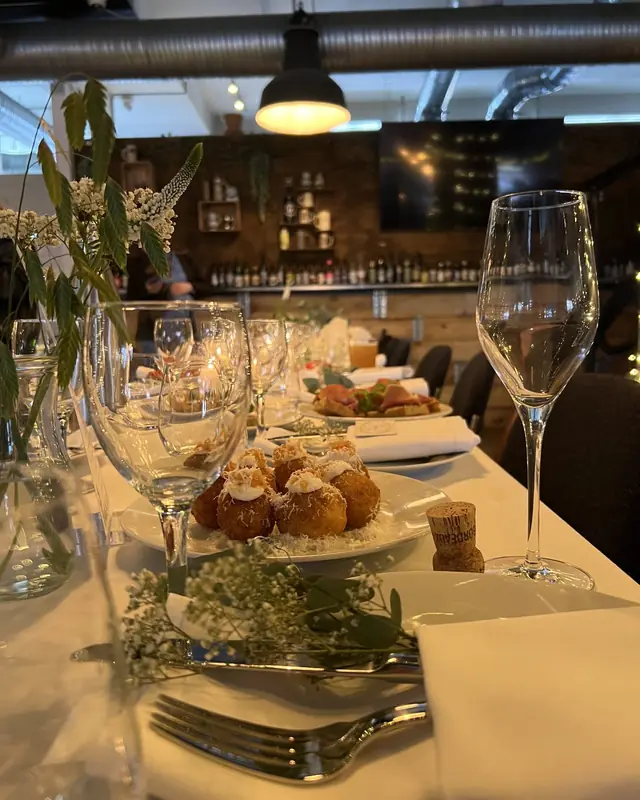 Party table with canapés and wine glasses